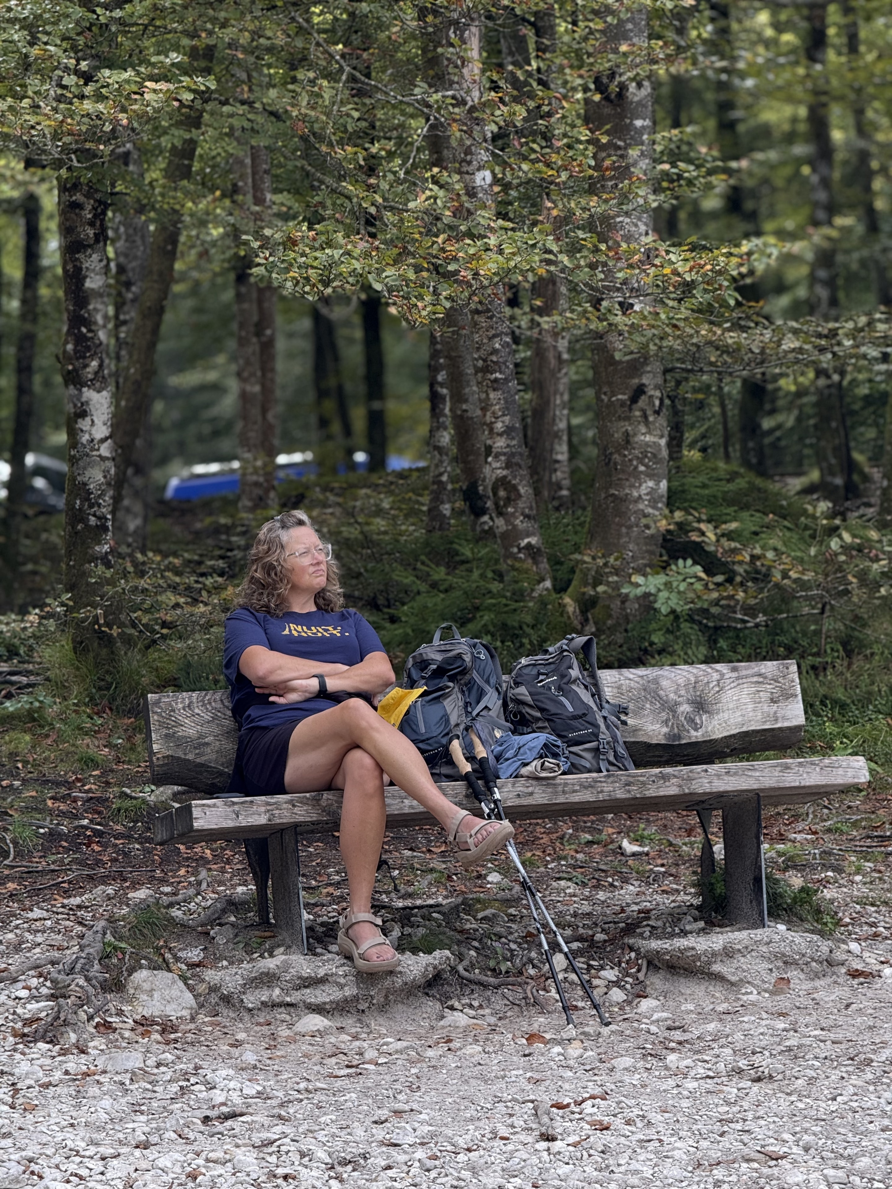 Cheryl resting on a bench during a forest hike