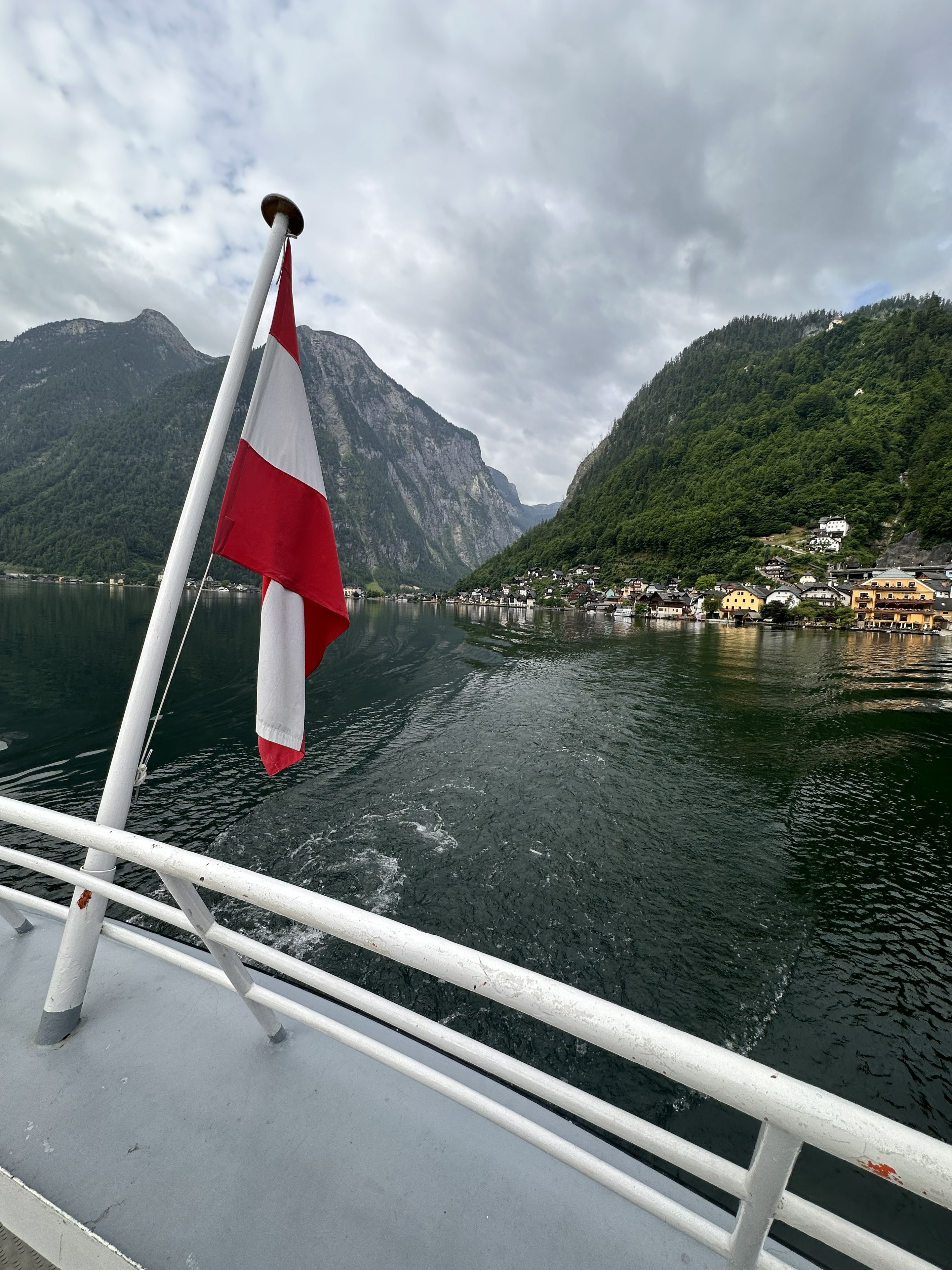 Ferry leaving Hallstatt with the Austrian flag at the stern