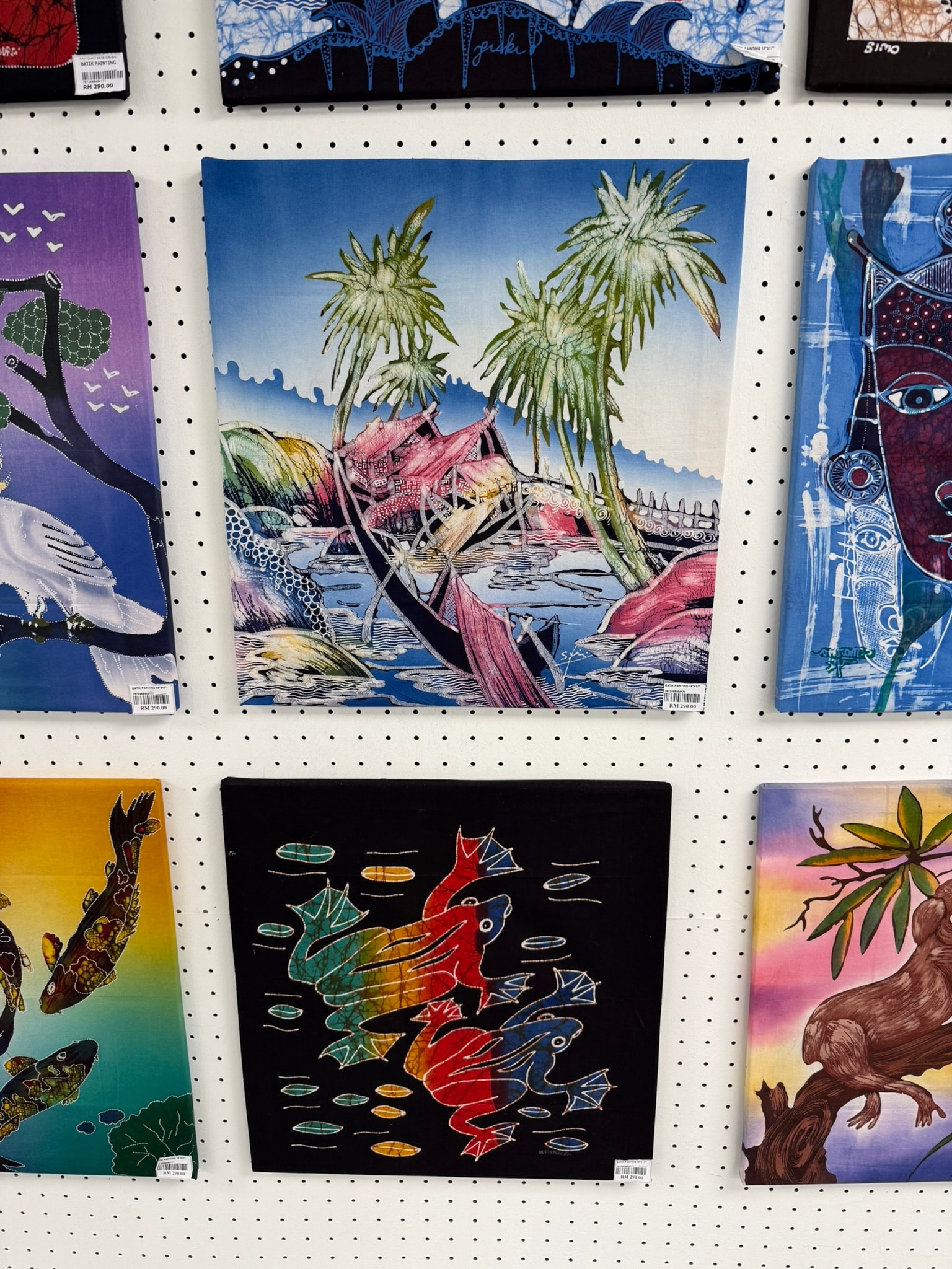 A wall filled with colorful finished batik pieces at the artist studio in Kuala Lumpur