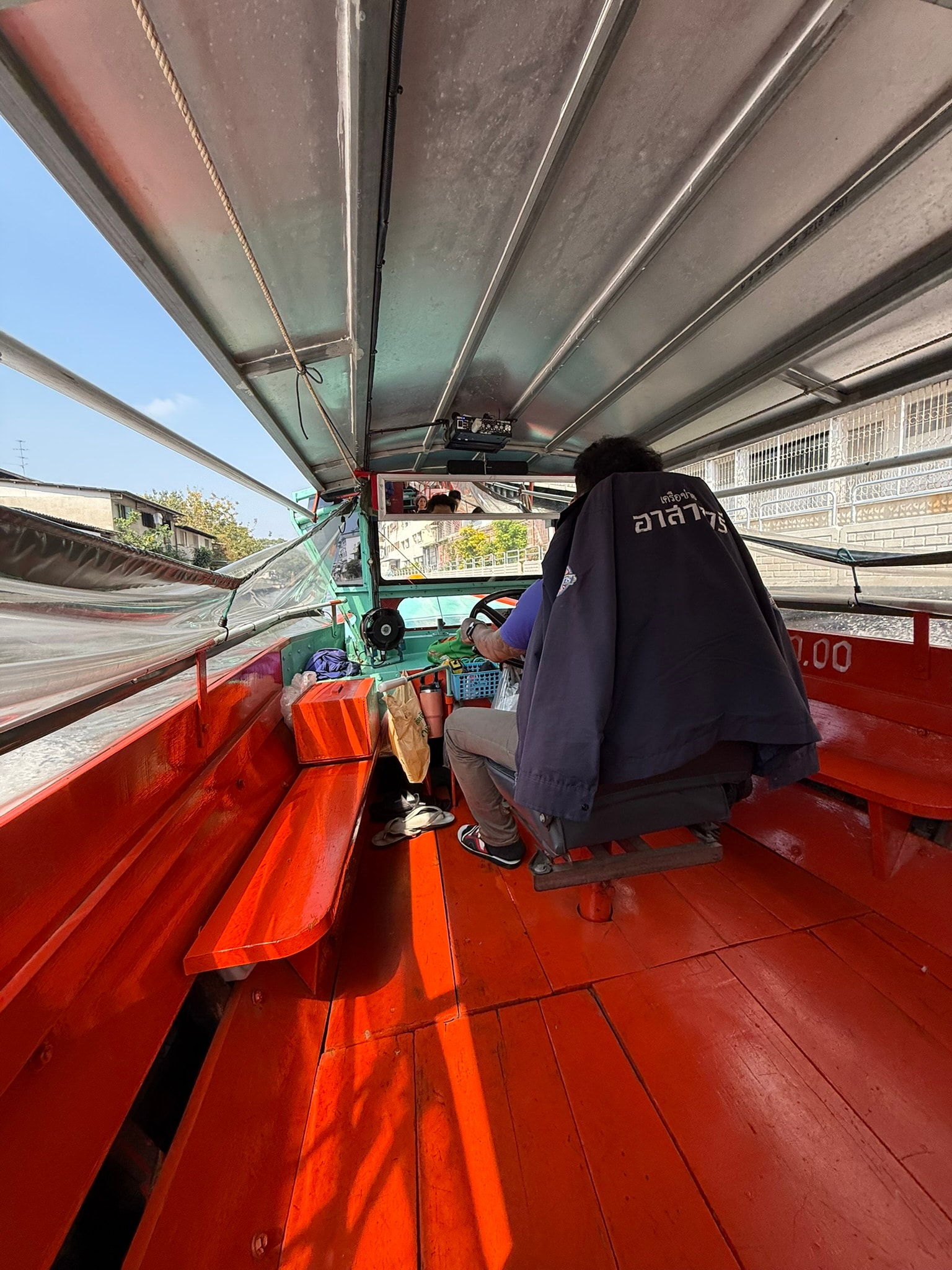 Passengers riding a Bangkok canal boat