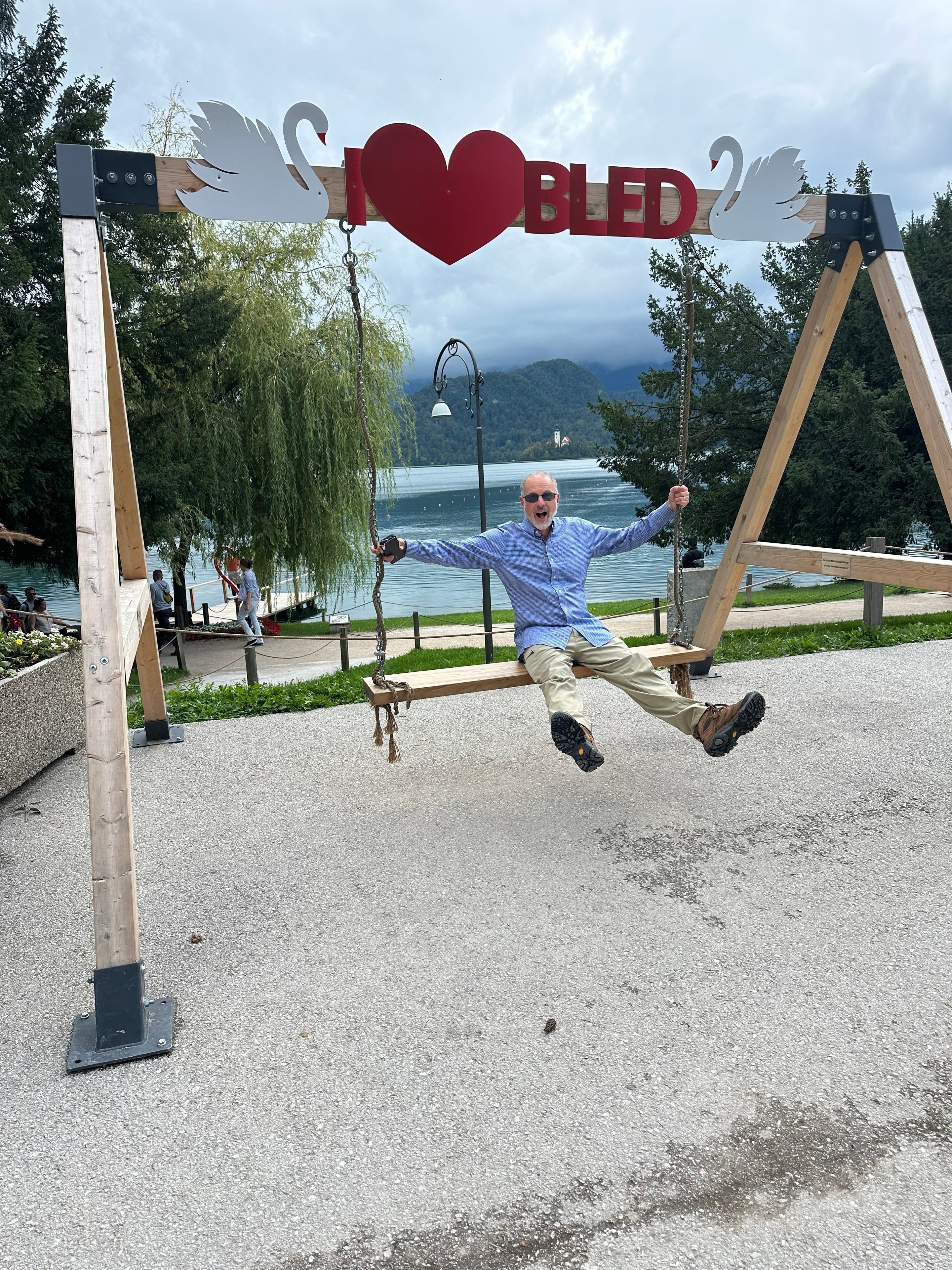Steve on a swing overlooking Lake Bled in Slovenia