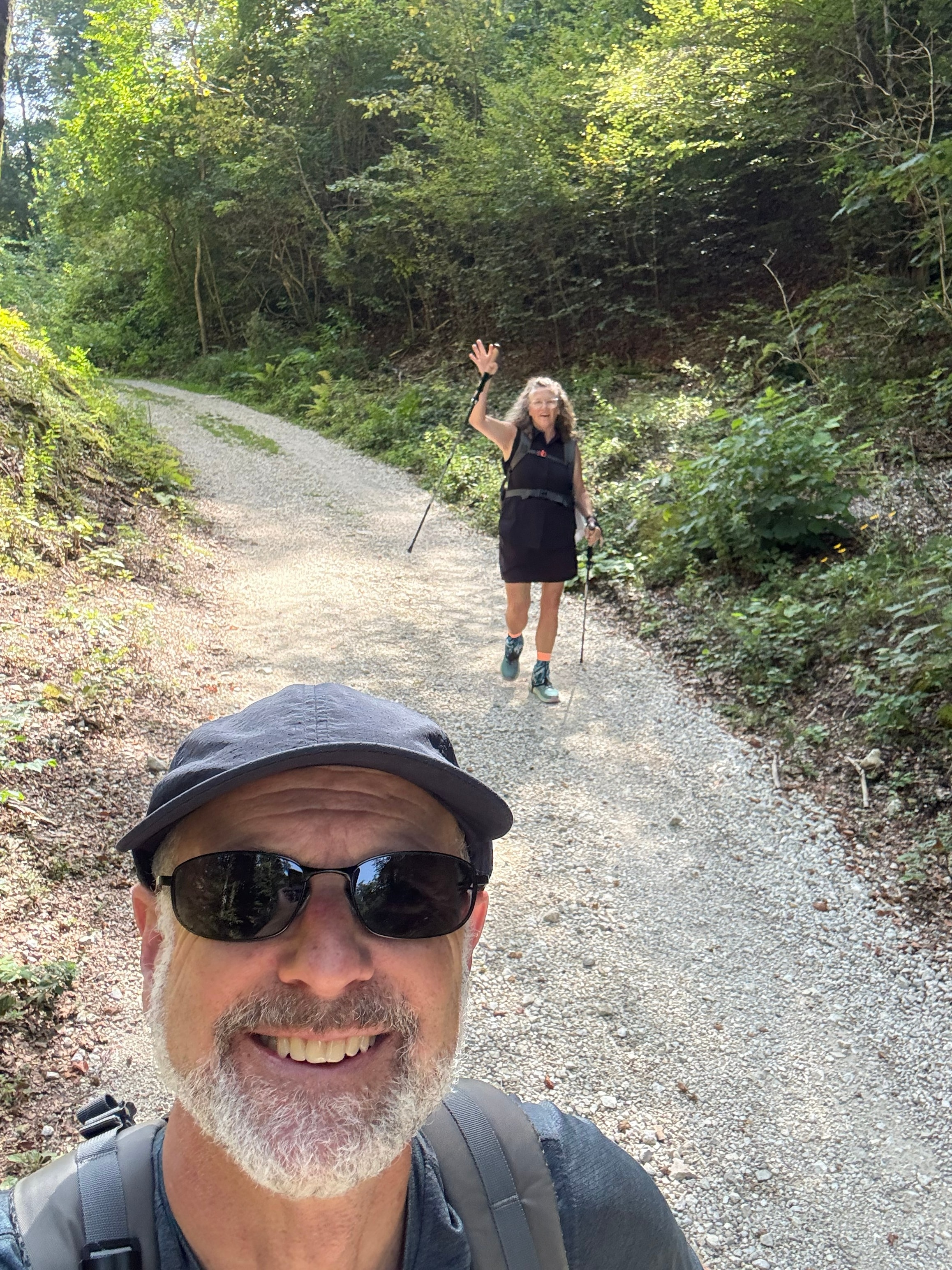 Cheryl and Steve hiking together on a wooded trail